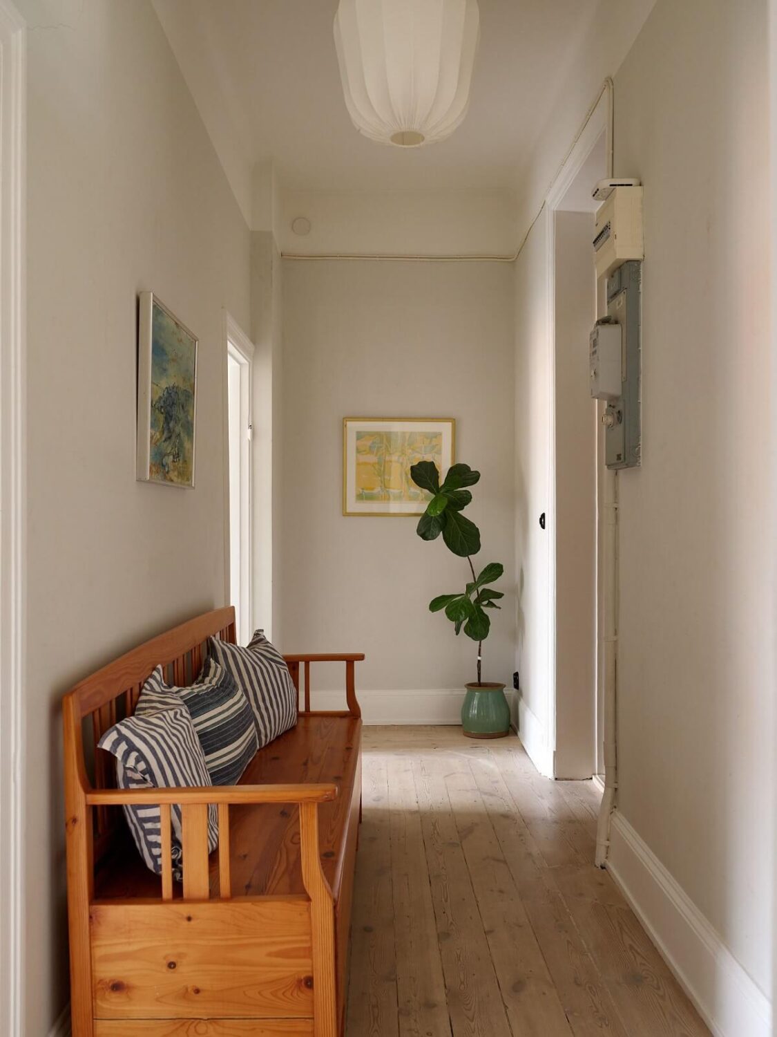 A Green Kitchen in a Gray Family Apartment 14 hallway with wooden bench