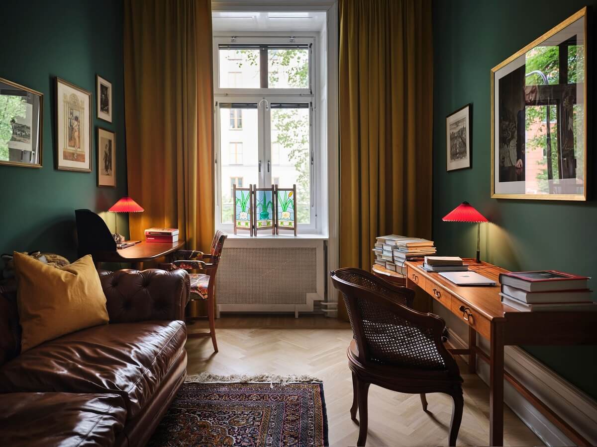 A Classic Stockholm Apartment with Floral Wallpaper 7 home office with dark green walls and ochre yellow curtains nordroom
