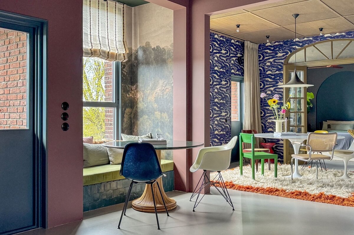 Color and Graphic Design in the Home of a Dutch Interior Stylist 16 kitchen nook with wallpaper and window bench