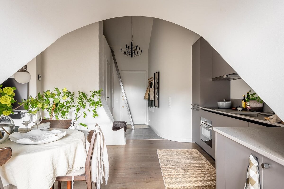 An Attic Studio Apartment with a Glass Room Divider 16 kitchen view into hall