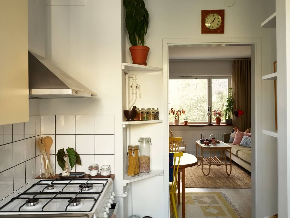 A Swedish Apartment with a Tiny Terracotta Brown Bedroom 12 kitchen view into living room