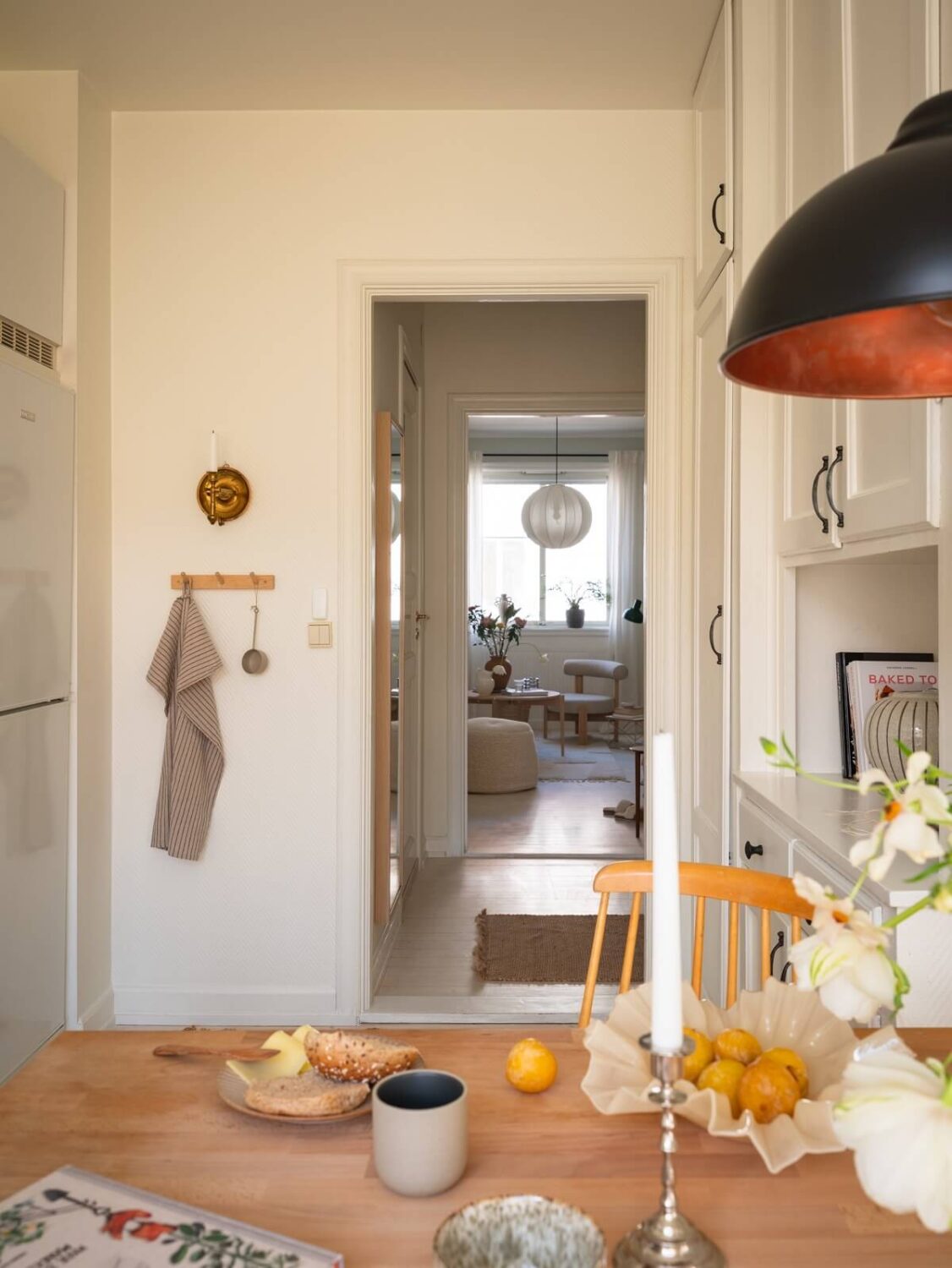 Calm Color Tones in a Light Scandinavian Studio Apartment 13 kitchen view into studio