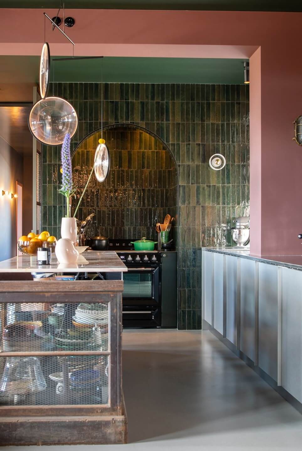 Color and Graphic Design in the Home of a Dutch Interior Stylist 9 kitchen with island pink walls and green tiles