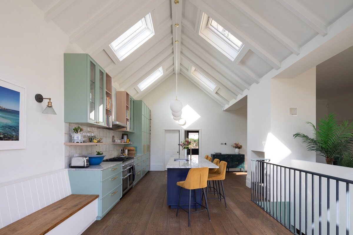 A Colorful London Family Home Renovated by Fraher & Finlay 9 kitchen with pitched ceiling and skylights