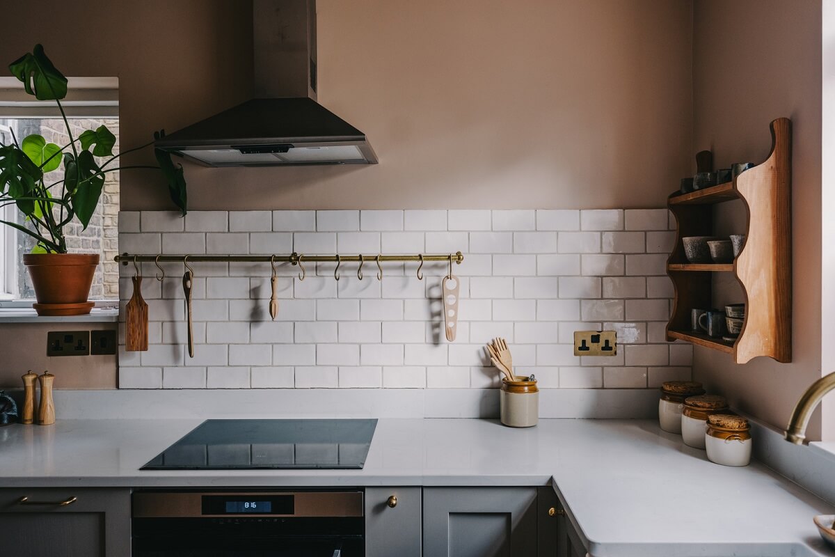 A Small London Apartment Filled with Books 10 kitchen with white tiles and setting plaster walls