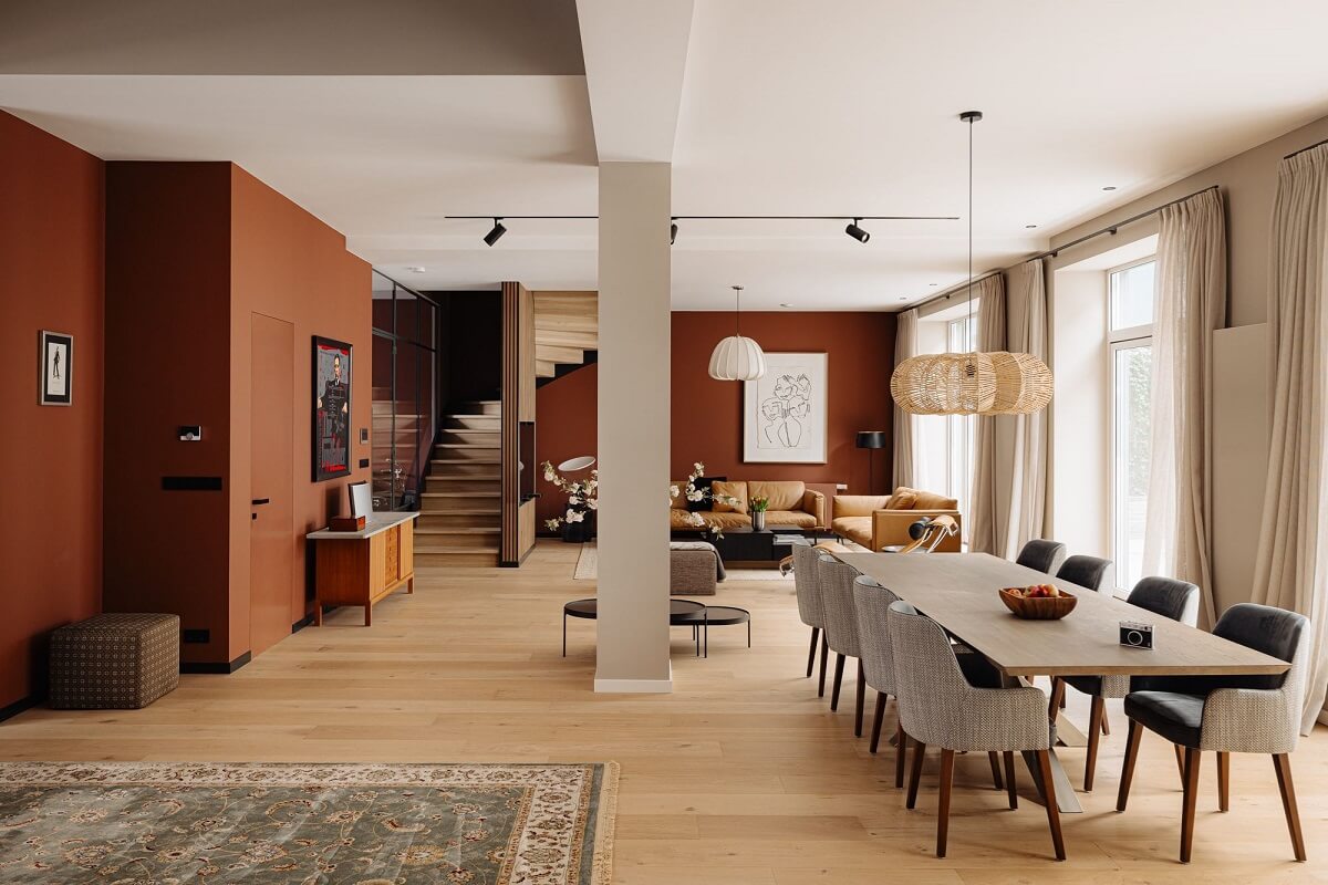 A Modern Garage Conversion in The Netherlands 4 large dining table in living room with brown walls