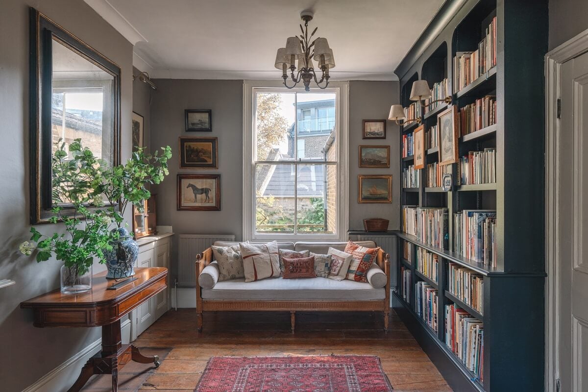 A Warm Muted Color Palette in a Victorian House 8 library room with blue bookcases