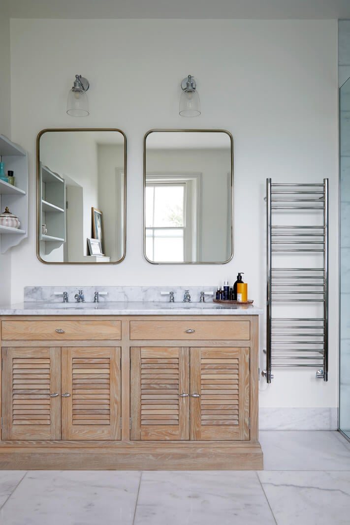 A Colorful London Family Home Renovated by Fraher & Finlay 27 light bathroom with wooden vanity