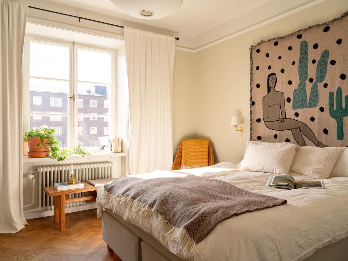 A Stockholm Apartment with Bright Green Color Accents 13 light bedroom with wall tapestry