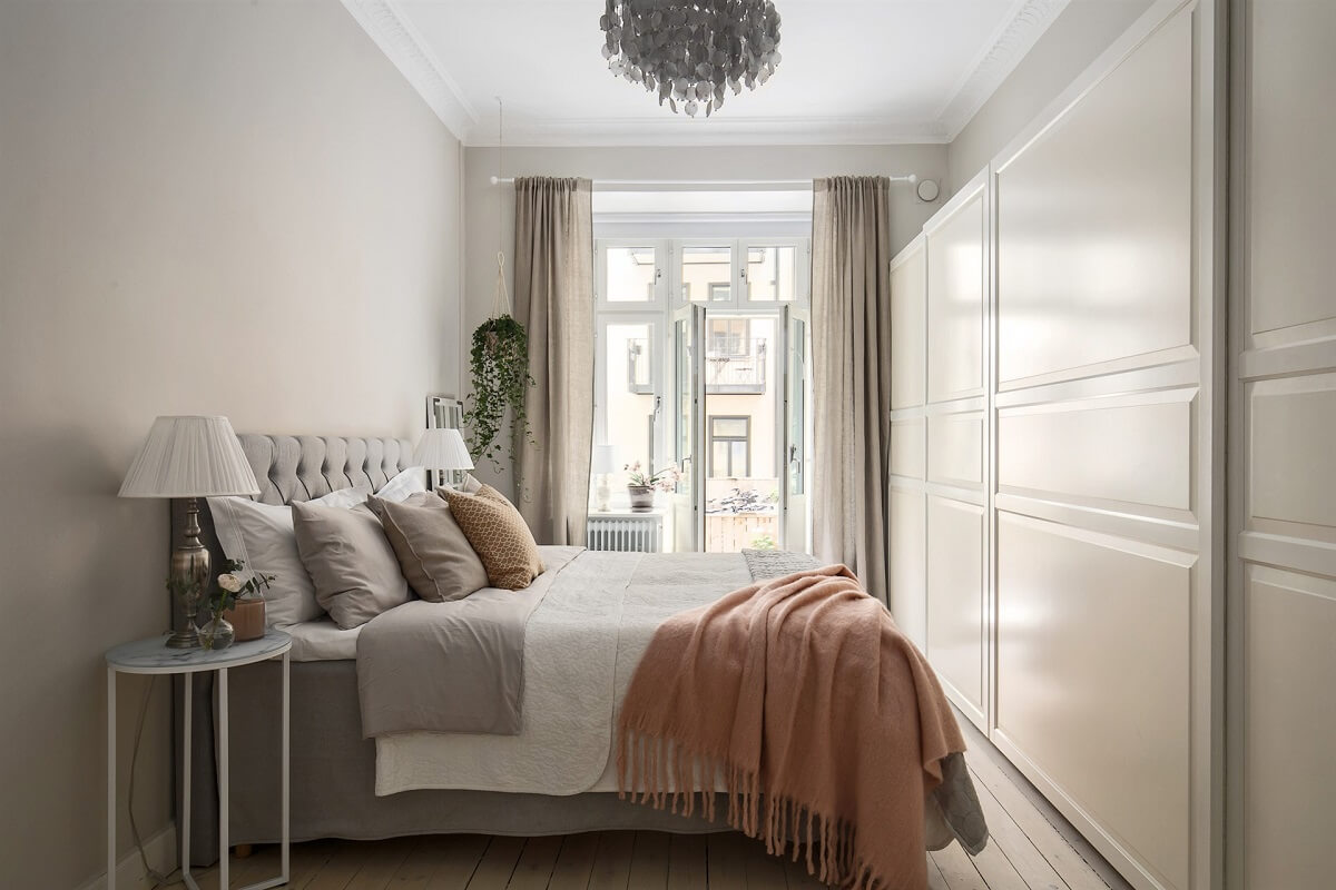 A Swedish Apartment with an Exposed Brick Wall 10 light bedroom with wardrobe wall