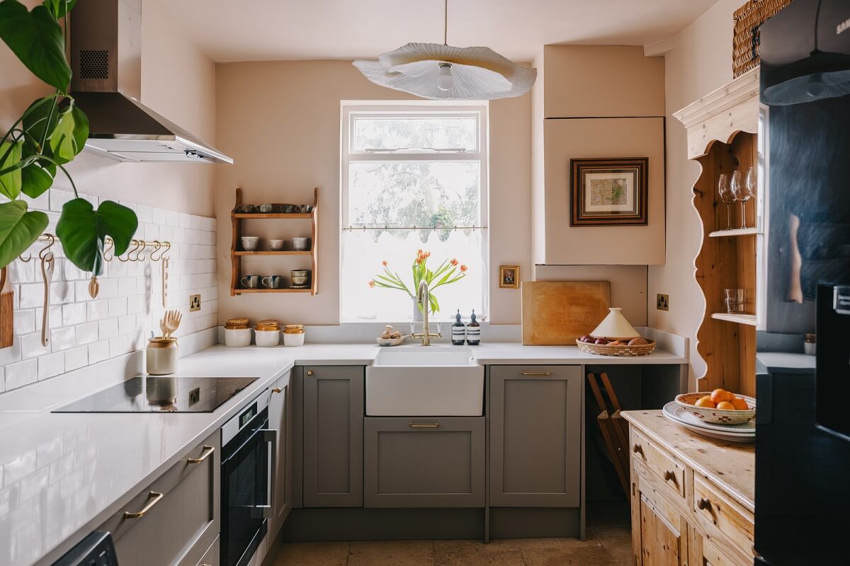 A Small London Apartment Filled with Books 8 light gray kitchen with butler sink and setting plaster farrow and ball walls nordroom