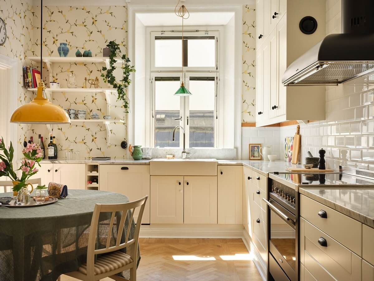 A Classic Stockholm Apartment with Floral Wallpaper 11 light kitchen with yellow floral wallpaper and round dining table nordroom