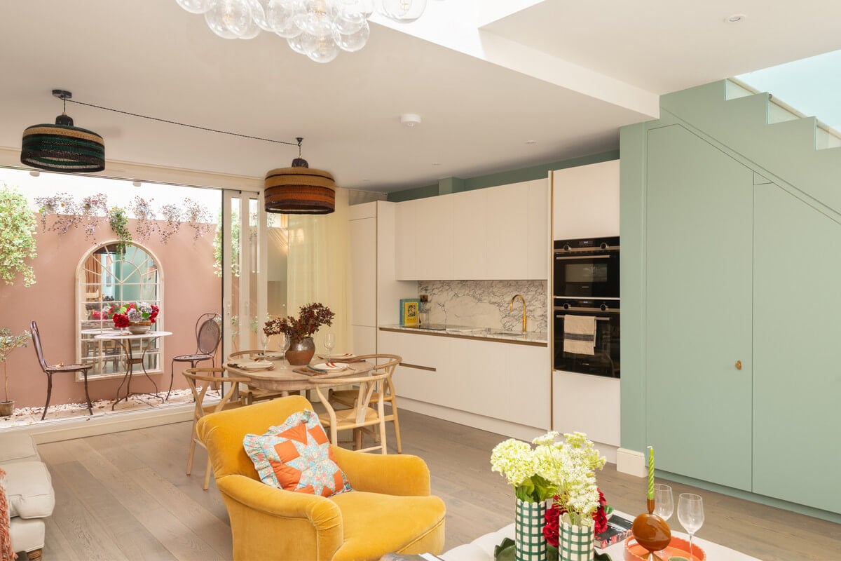 A Light London Maisonette in a Former Artist's Studio 8 light living space with yellow chair and green stair