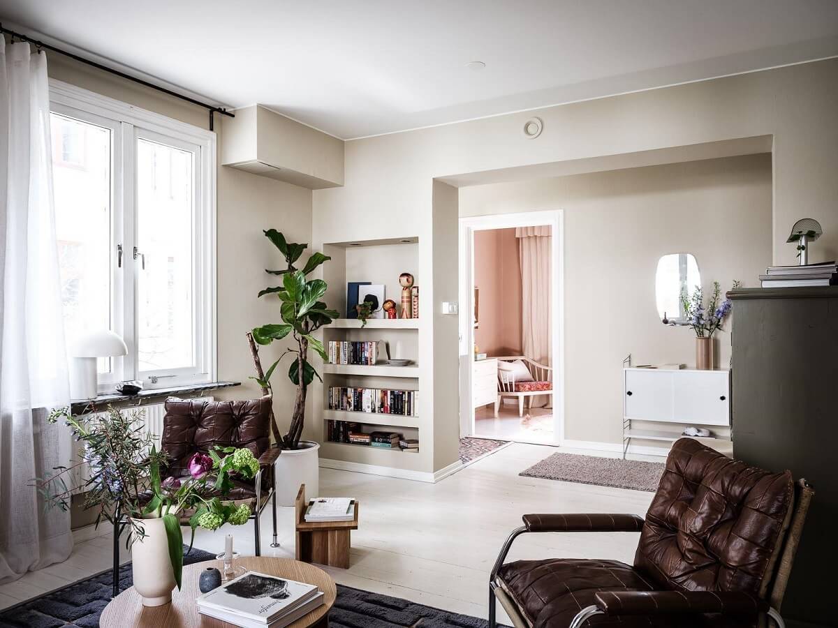A Scandinavian Apartment with a Rust Red Bedroom 5 living room beige walls bookshelves
