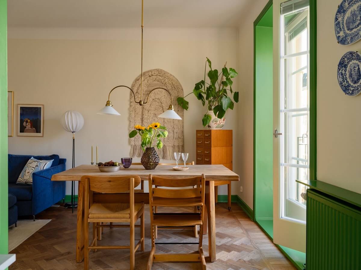A Stockholm Apartment with Bright Green Color Accents 6 living room dining table and green windows