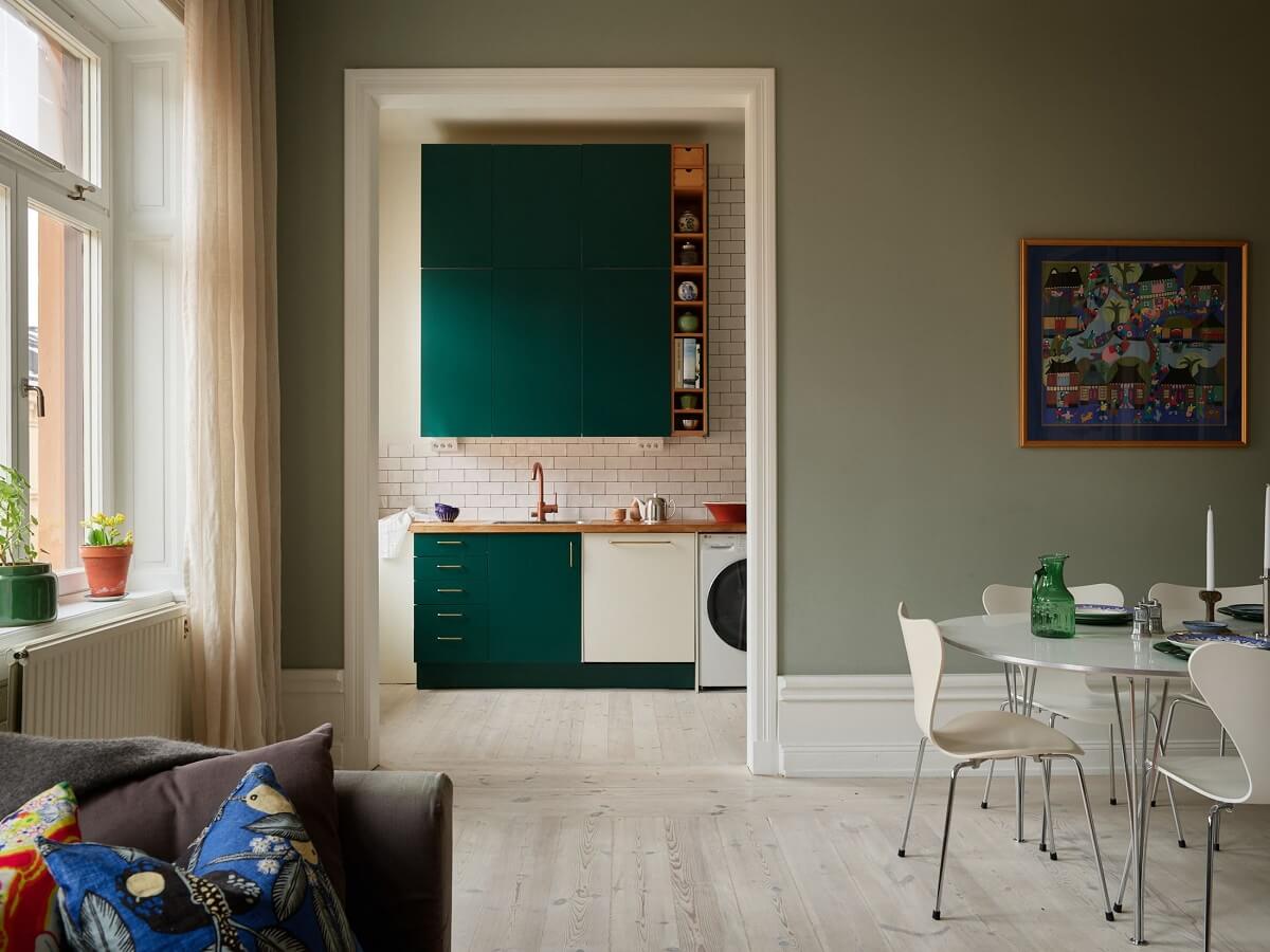 A Green Kitchen in a Gray Family Apartment 8 living room view into kitchen