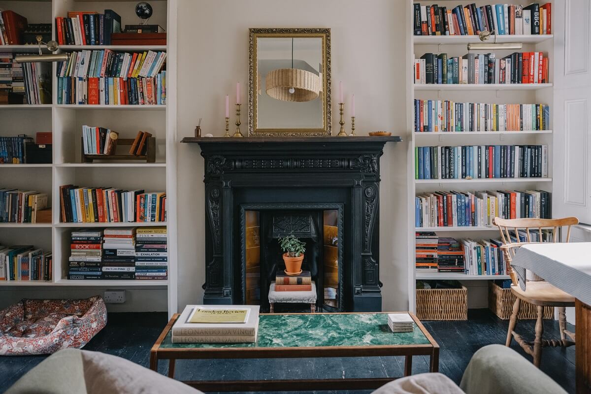 A Small London Apartment Filled with Books 4 living room with black fireplace and bookshelves