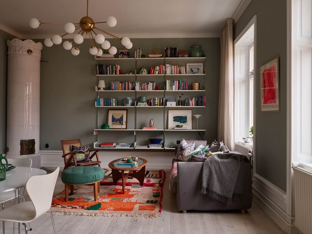 A Green Kitchen in a Gray Family Apartment 1 living room with bookshelves and fireplace