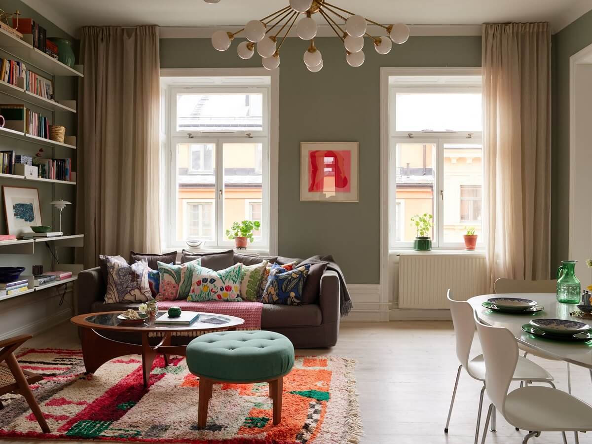 A Green Kitchen in a Gray Family Apartment 2 living room with colorful rug and bookshelves