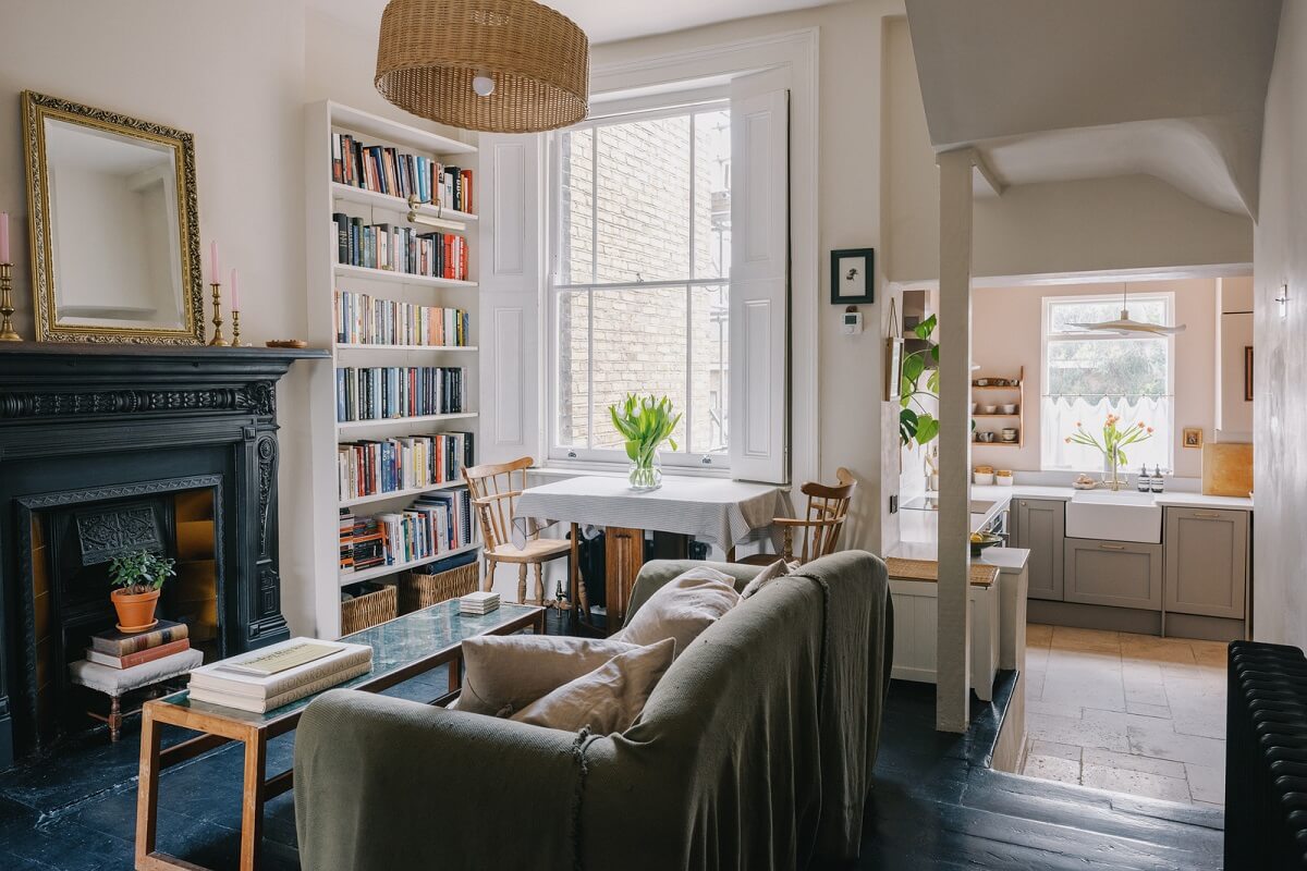 A Small London Apartment Filled with Books 1 living room with dark floor and black fireplace