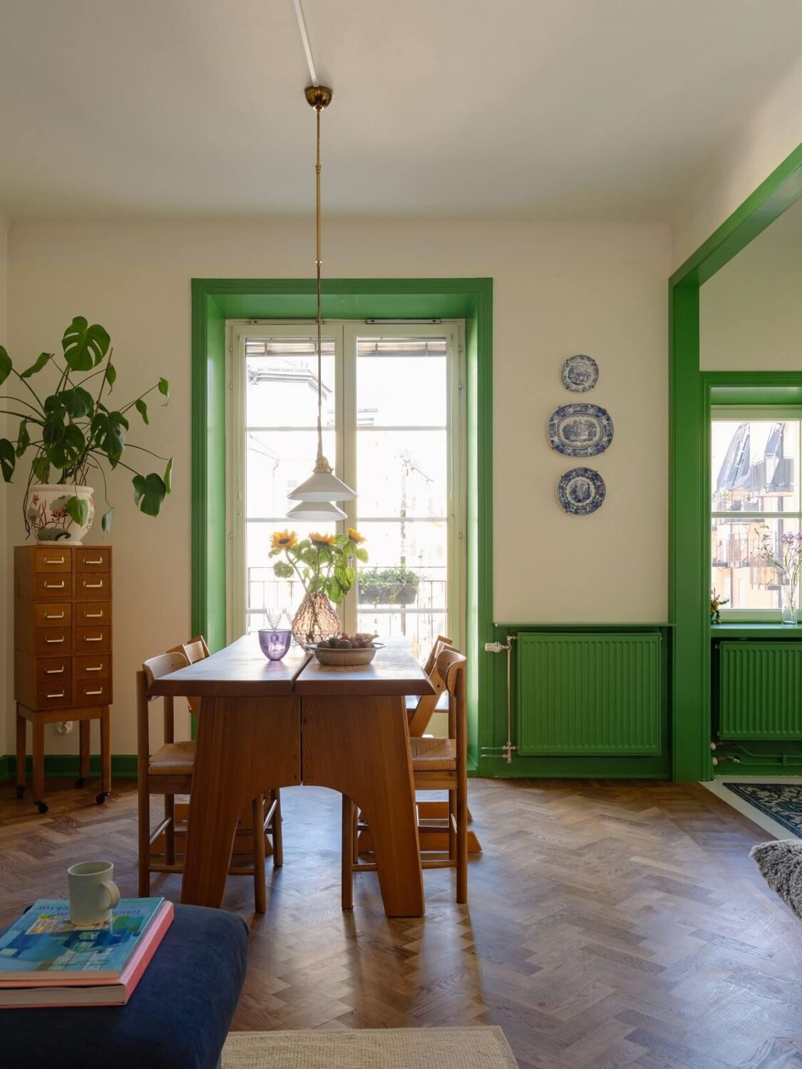 A Stockholm Apartment with Bright Green Color Accents 3 living room with dining table and green color accents