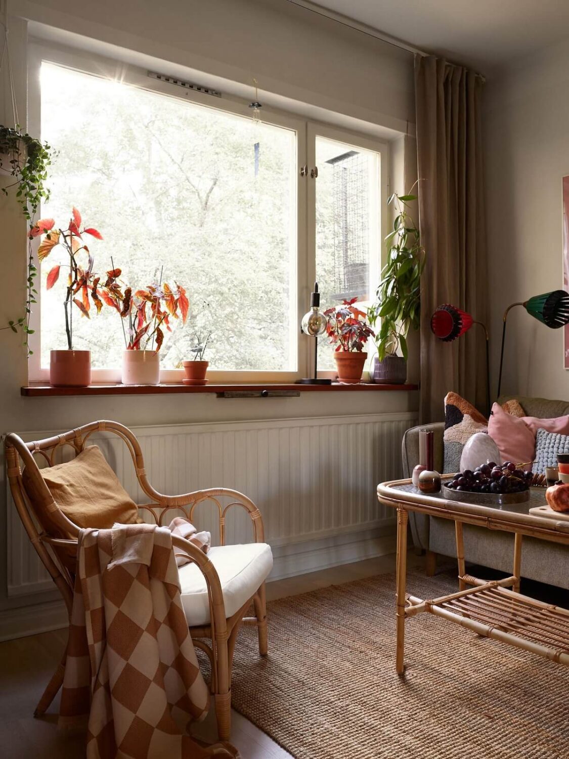 A Swedish Apartment with a Tiny Terracotta Brown Bedroom 2 living room with jute rug