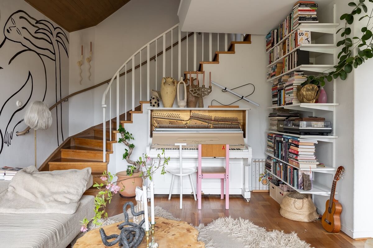 A Swedish Family House with Wall Murals and Art 4 living room with mural and bookshelves