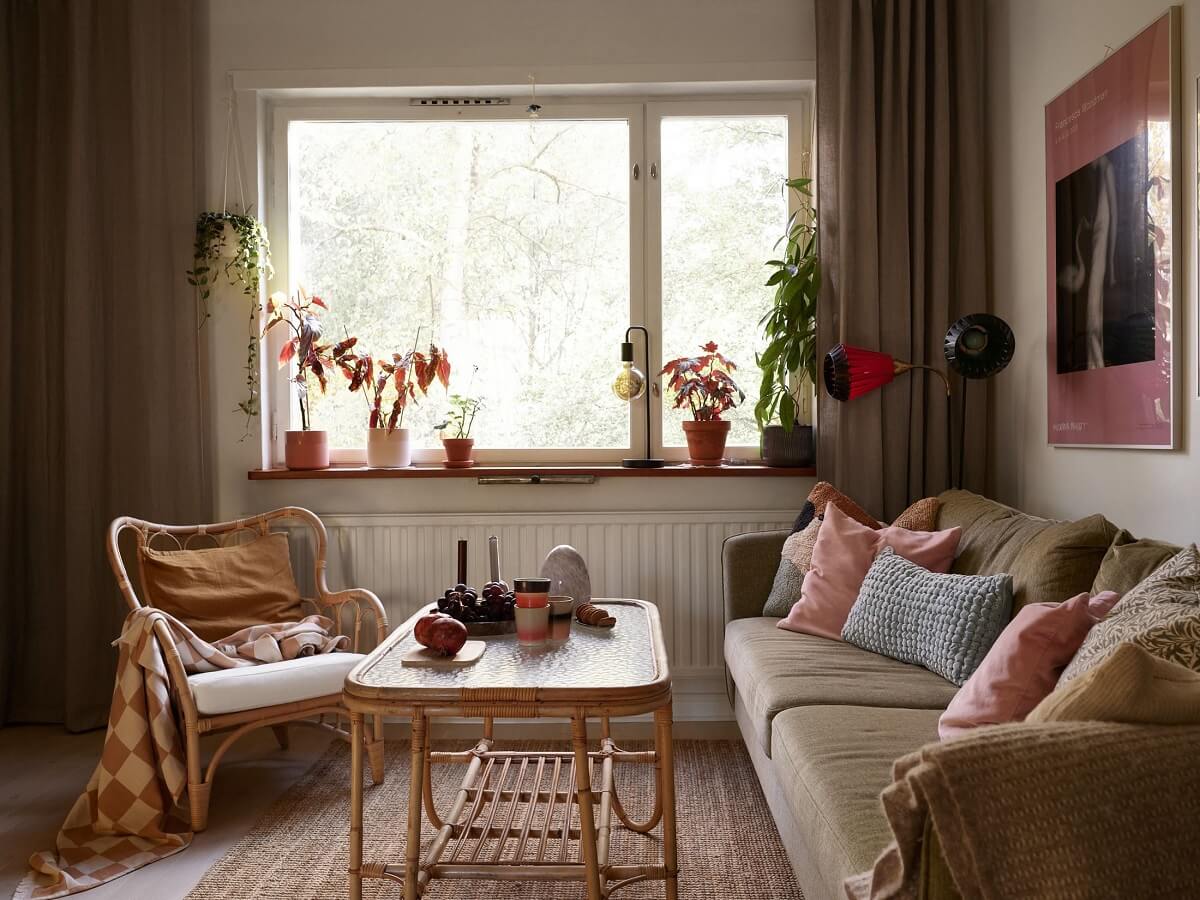 A Swedish Apartment with a Tiny Terracotta Brown Bedroom 3 living room with pastel pink cushions