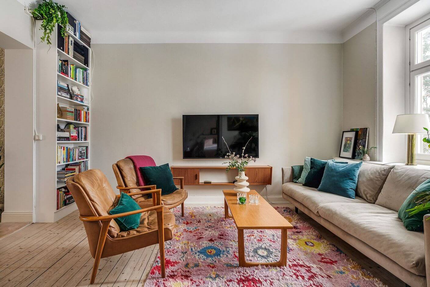 A Swedish Family Apartment with a Butter Yellow Kitchen 10 living room with pink rug