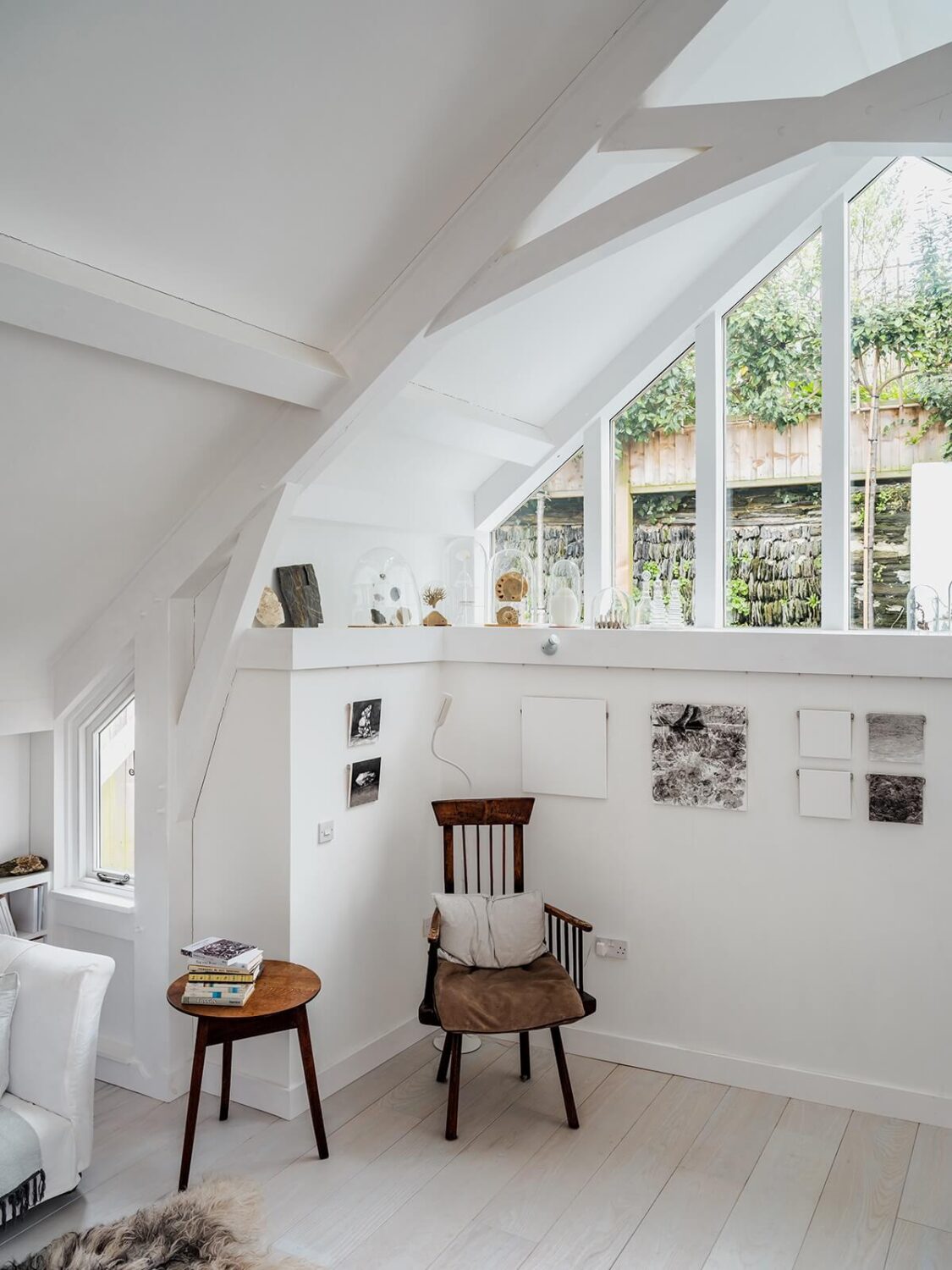 A Coastal White Painter's Home with Reclaimed Features in Cornwall 9 living room with pitched ceiling and large window
