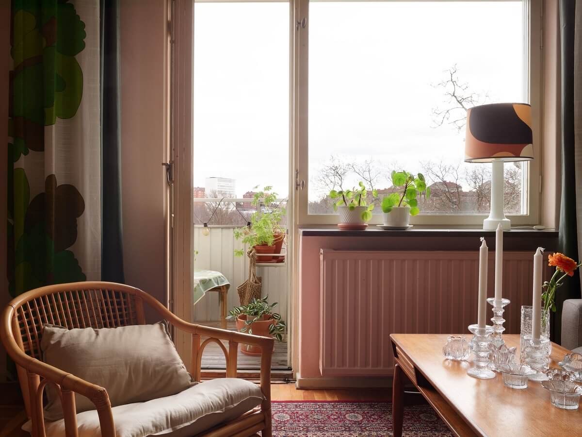 Revisiting a Small Green and Pink Midcentury Apartment 11 living room with rattan chair
