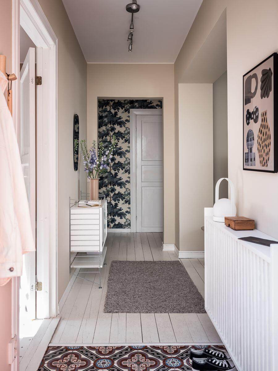 A Scandinavian Apartment with a Rust Red Bedroom 18 long hallway with beige walls