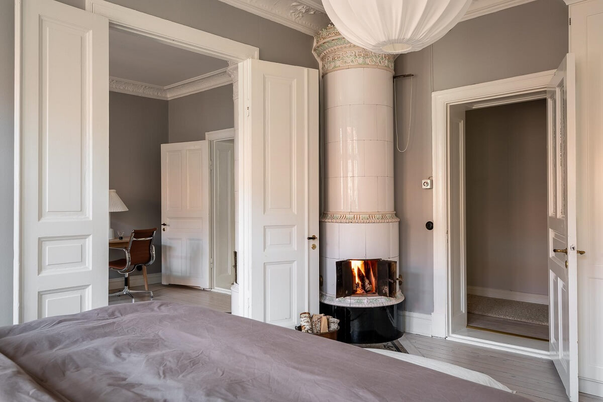A Stylish Light Gray Swedish Apartment 18 master bedroom with round fireplace
