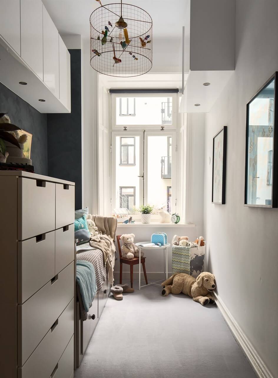 A Swedish Apartment with an Exposed Brick Wall 12 narrow kids bedroom with dark feature wall
