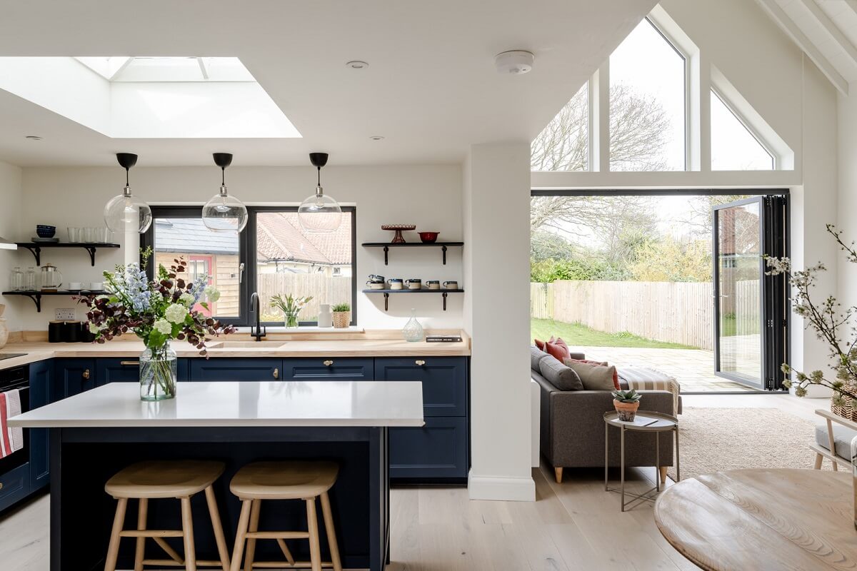 A Modern Barn House in the English Countryside 2 open plan kitchen living room blue cabinets nordroom