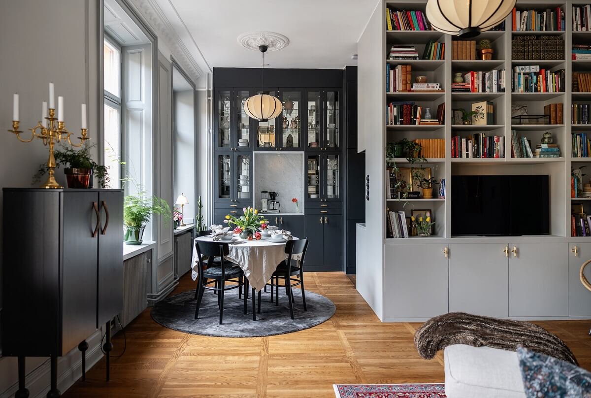 A Classic Swedish Apartment with a Dark Blue Bedroom 5 open plan living room with round dining table