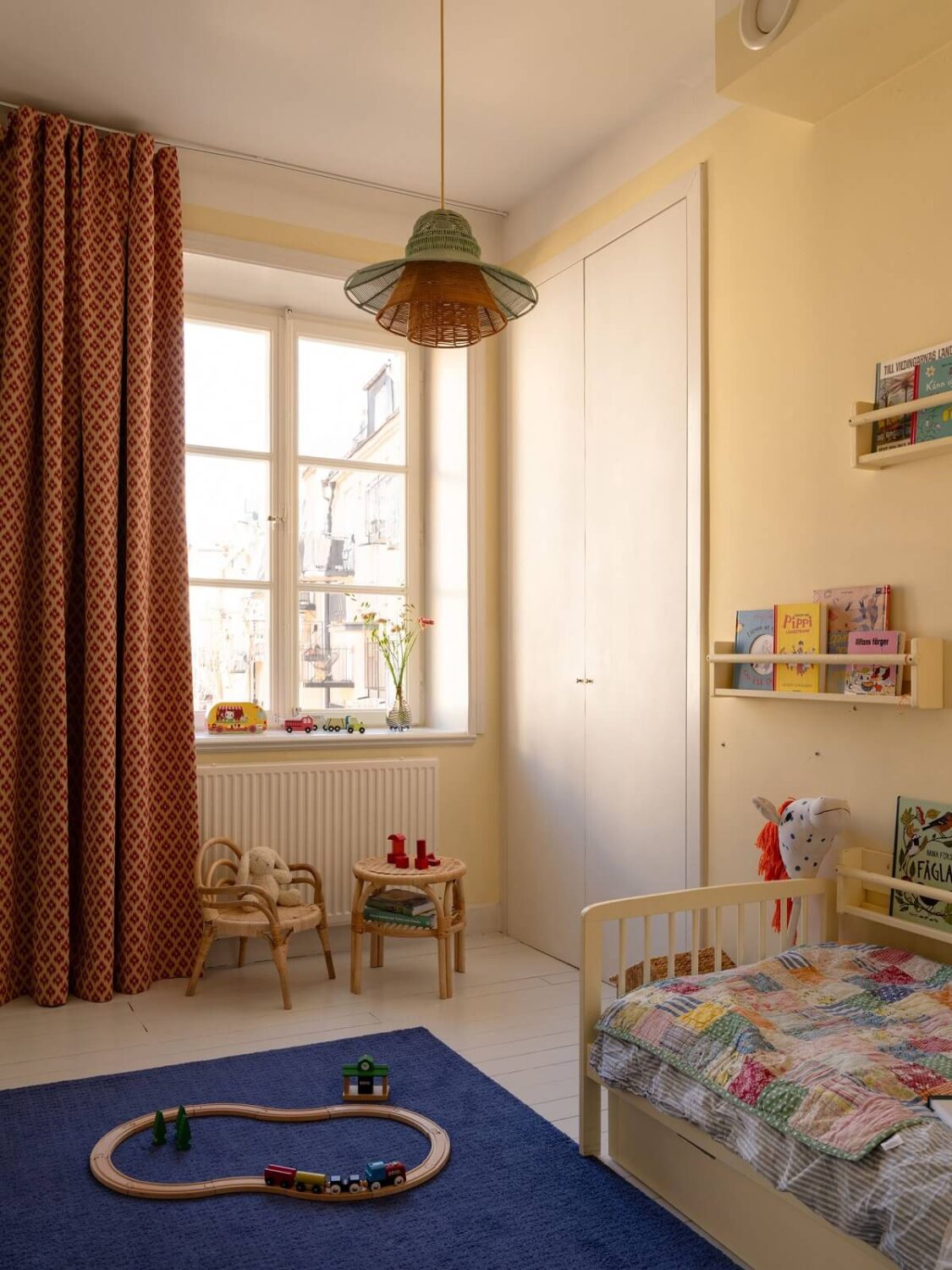 A Stockholm Apartment with Bright Green Color Accents 17 pale yellow children room