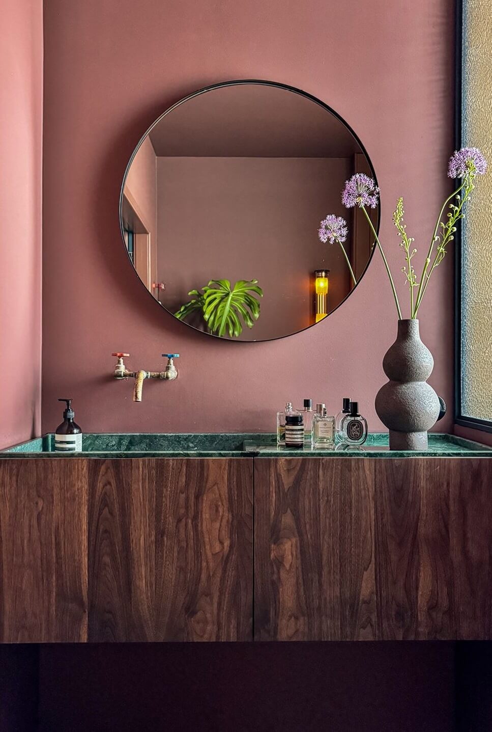 Color and Graphic Design in the Home of a Dutch Interior Stylist 32 pink bathroom with green marble sink