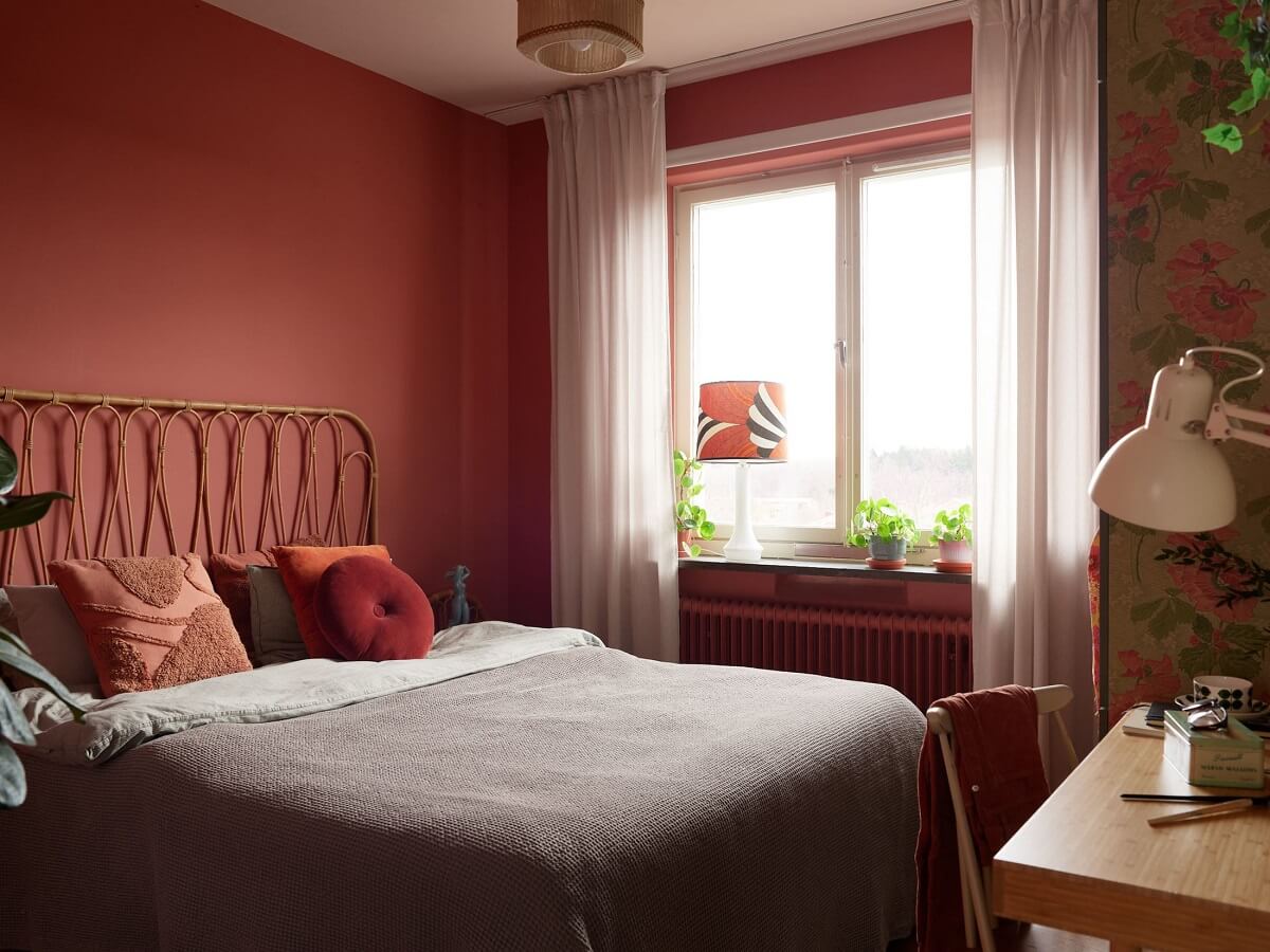 Revisiting a Small Green and Pink Midcentury Apartment 15 pink bedroom with rattan headboard