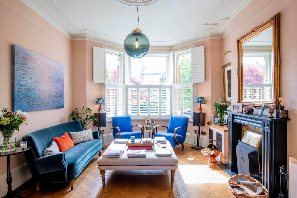 A Victorian House where the Kitchen is the Heart of the Home 5 pink living room with bay window and black fireplace