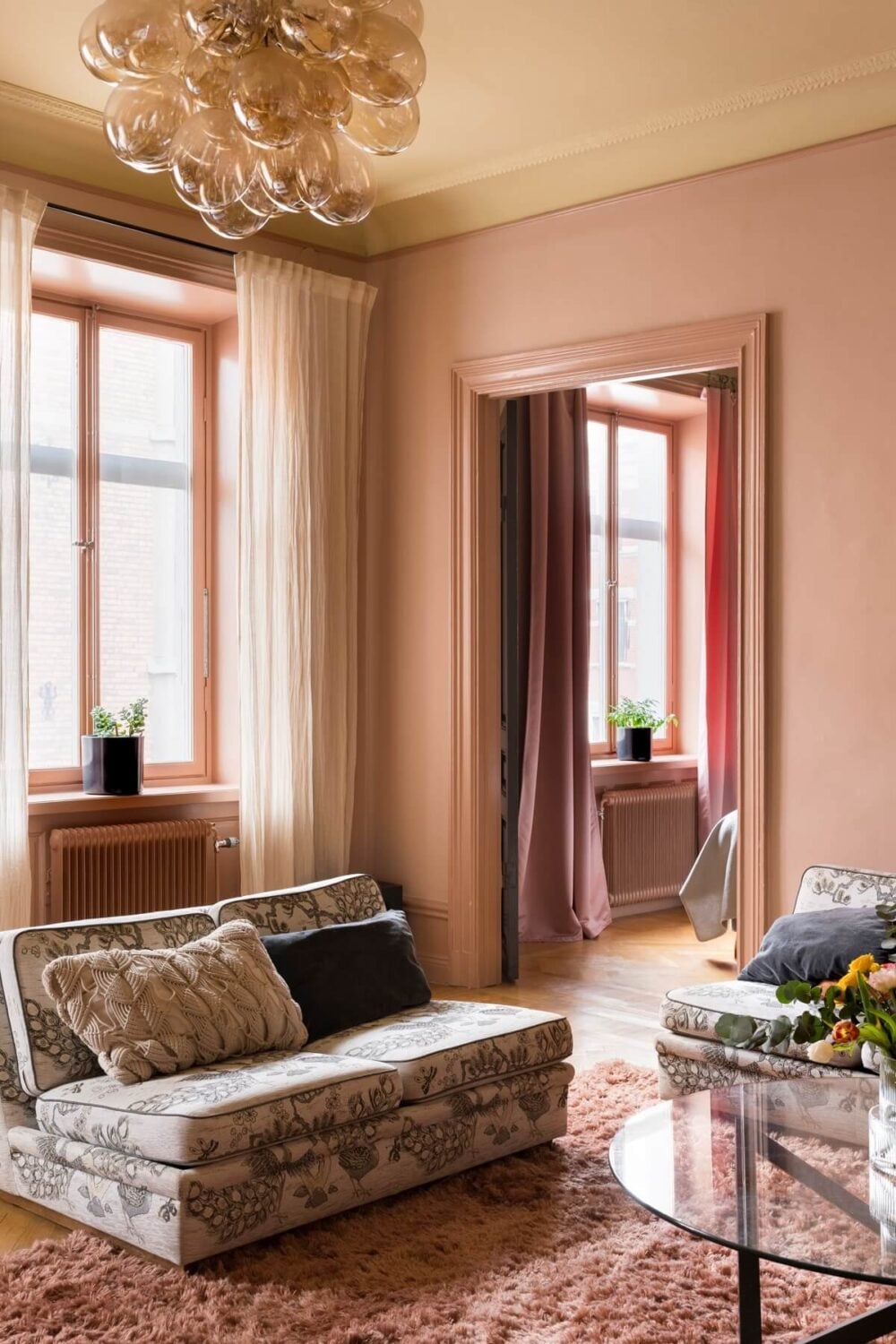A Pink Apartment with a Black Kitchen 4 pink living room with floral sofa