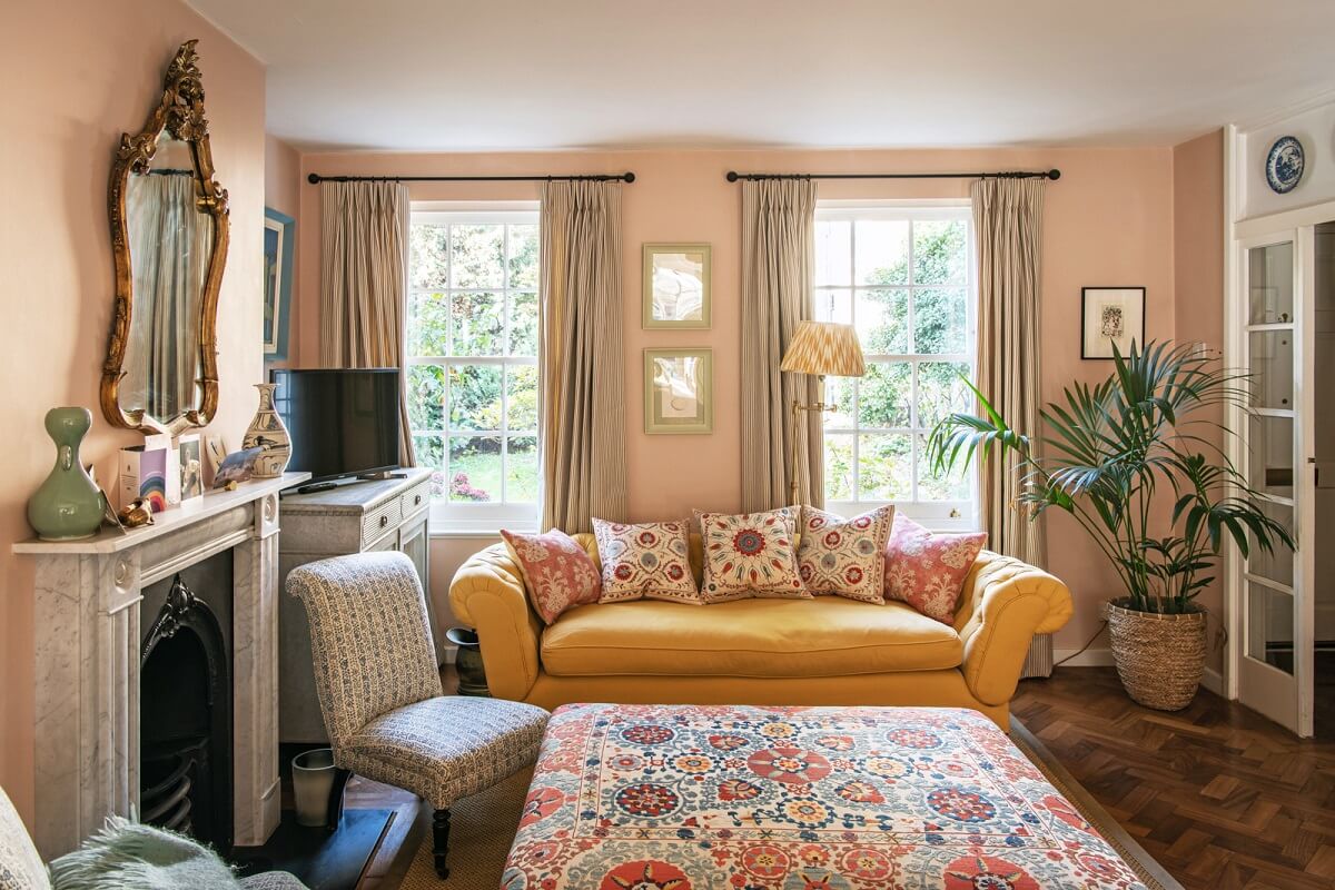 pink living room with yellow sofa