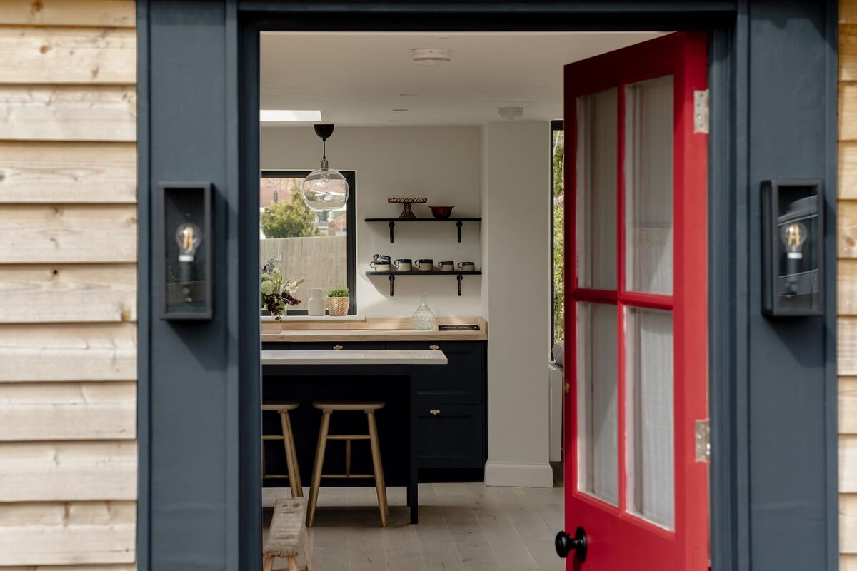 A Modern Barn House in the English Countryside 15 red front door