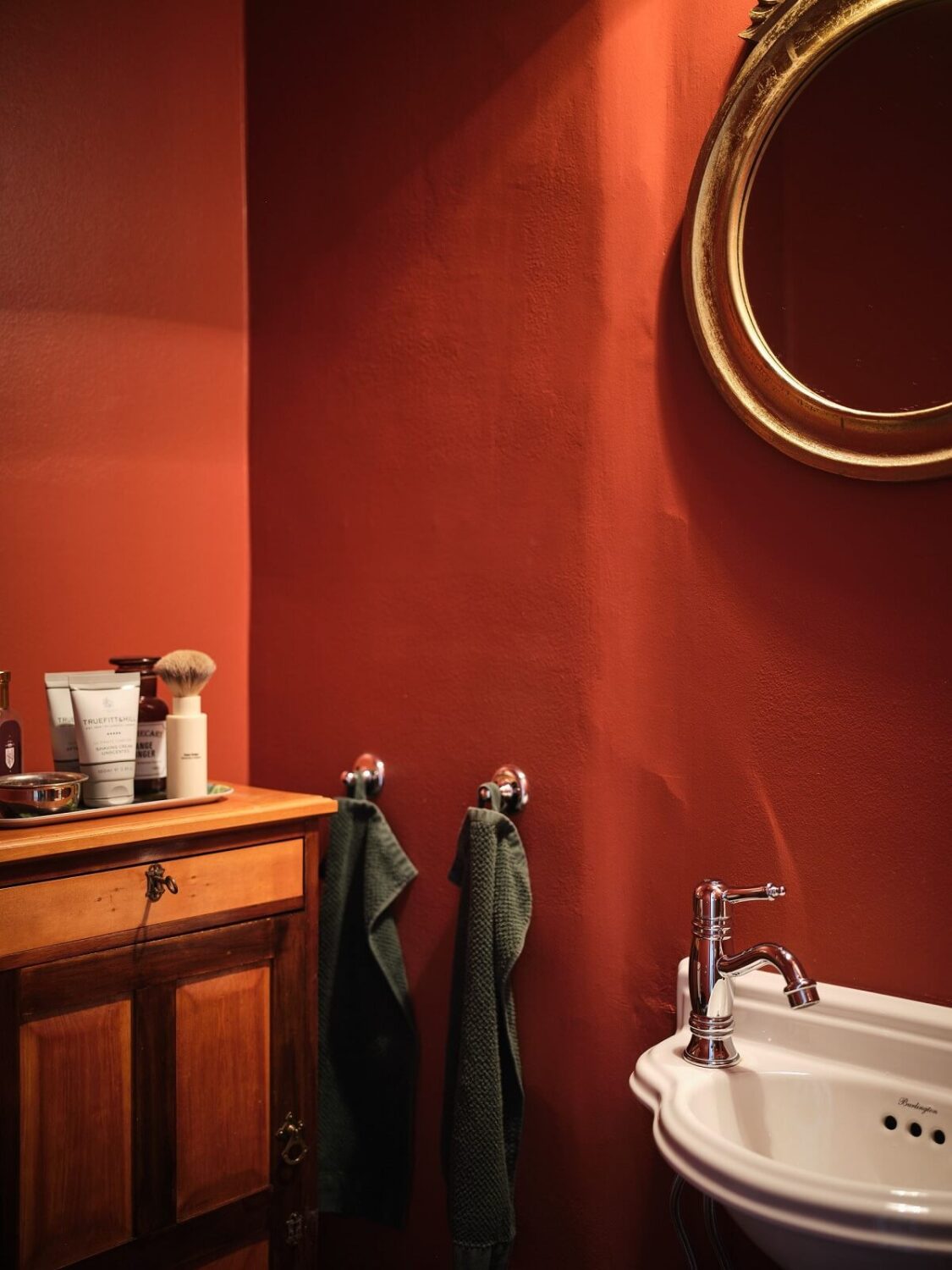 A Classic Stockholm Apartment with Floral Wallpaper 32 red powder room nordroom