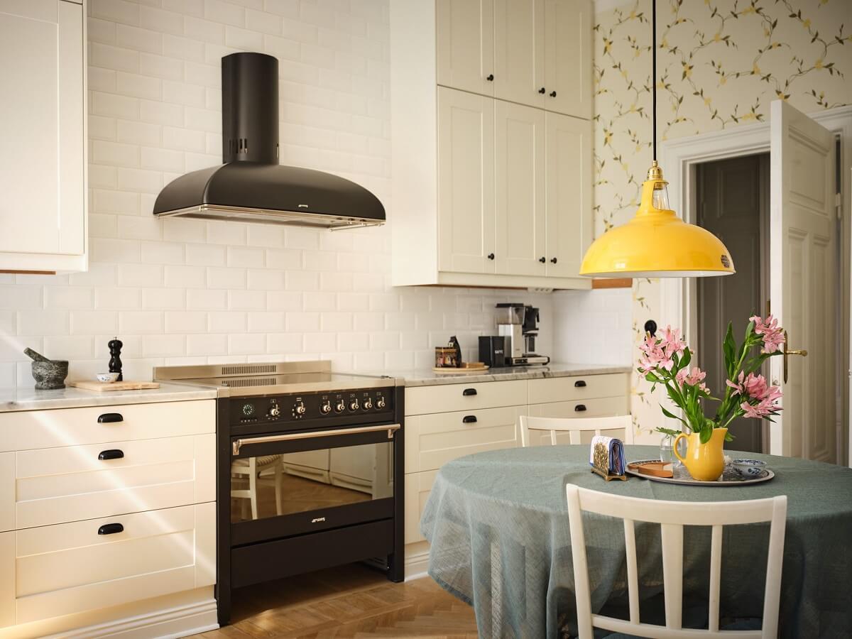A Classic Stockholm Apartment with Floral Wallpaper 13 round dining table with yellow pendant nordroom
