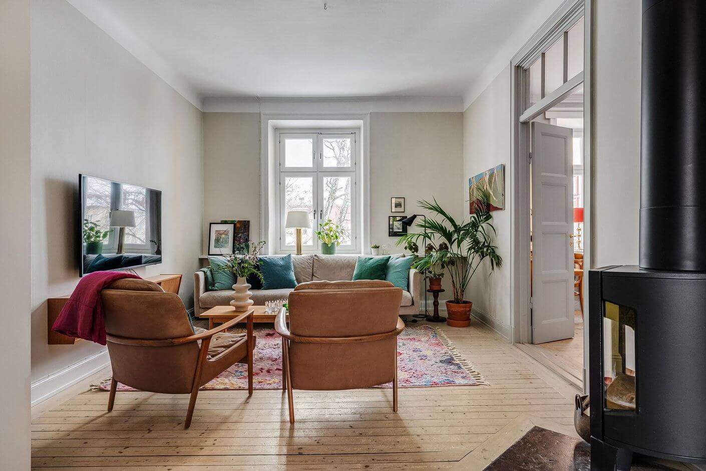 A Swedish Family Apartment with a Butter Yellow Kitchen 11 scandinavian living room with fireplace