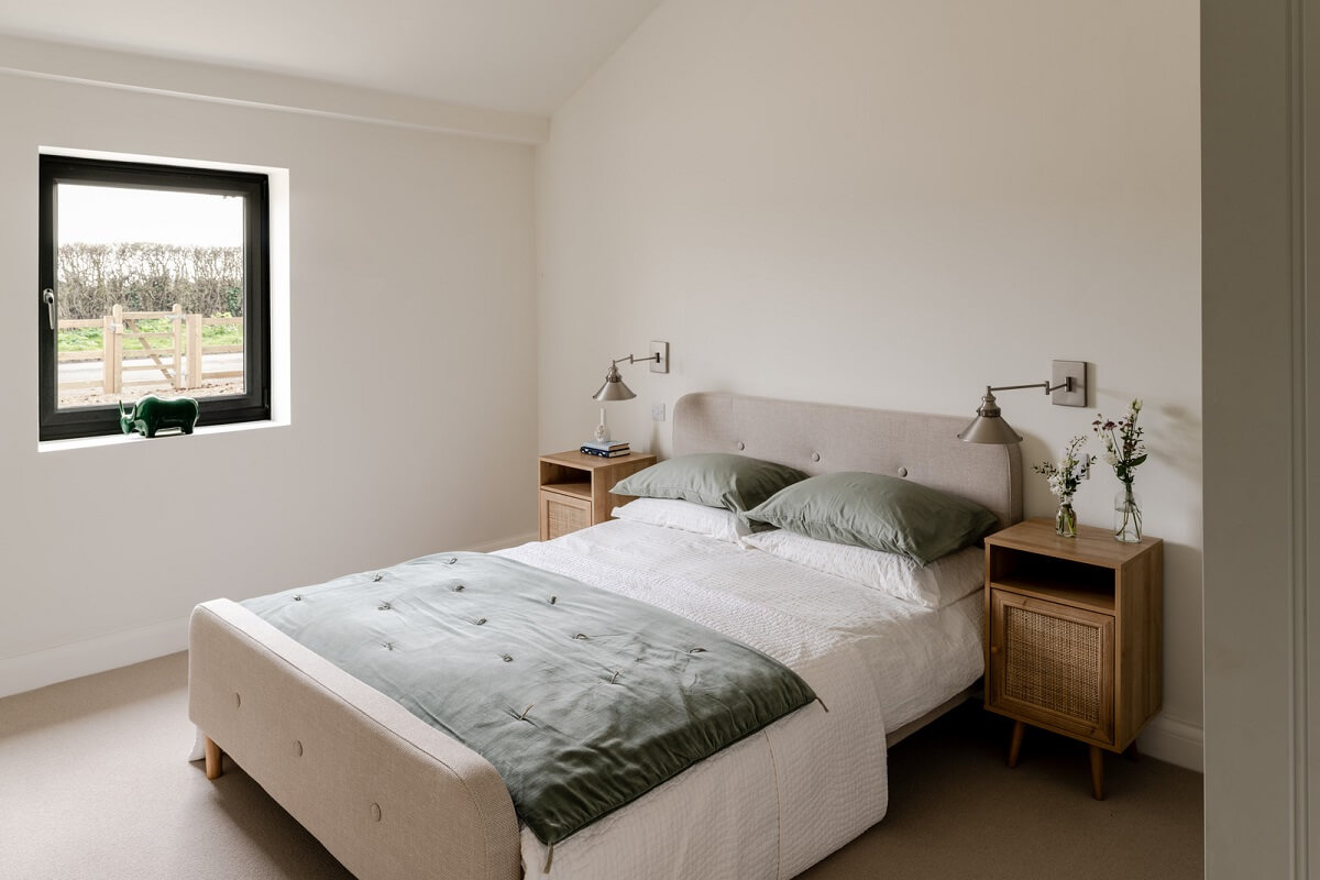 A Modern Barn House in the English Countryside 16 serene bedroom with green accents