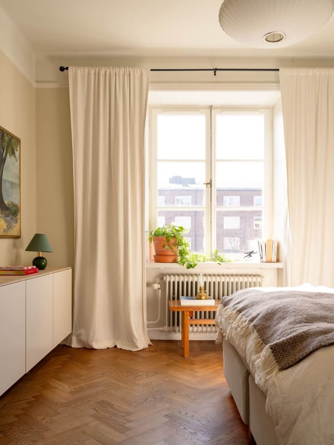 A Stockholm Apartment with Bright Green Color Accents 14 serene light filled bedroom wooden floor