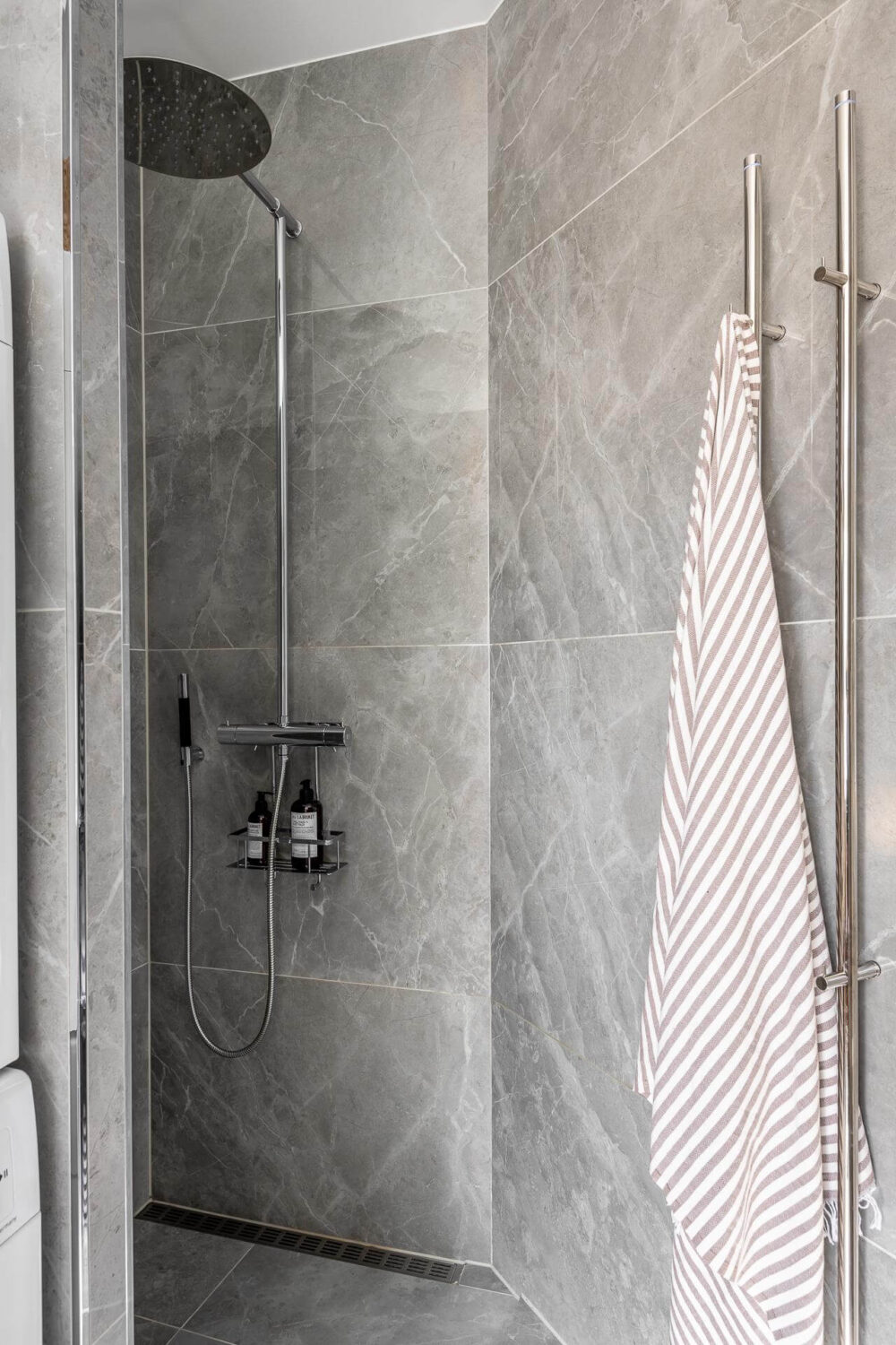 A Stylish Light Gray Swedish Apartment 20 shower with gray tiles