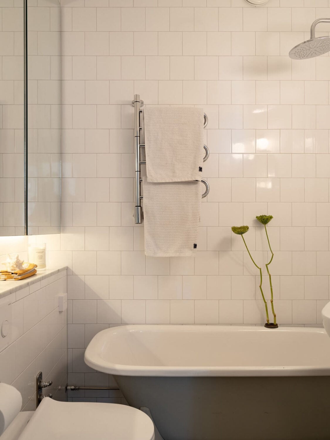 A Stockholm Apartment with Bright Green Color Accents 18 small bathroom with bath